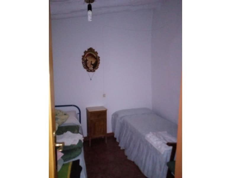 Charming village home interior in Armuna, Almeria, featuring simple furnishings and traditional deco.