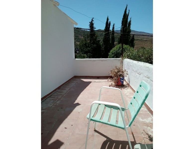 Terrace of a village property in Armuna, Almeria, with outdoor seating and scenic mountain views.