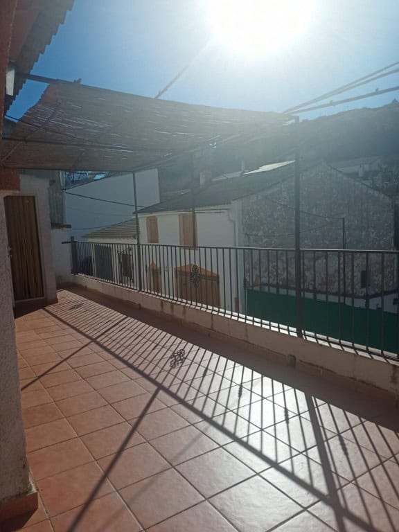 Traditional cave house in Fontanar, Jaen with a spacious balcony and scenic mountain views.