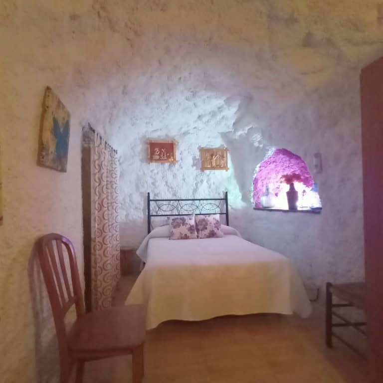 Unique cave house in Fontanar, Jaen with cozy interior and natural stone walls.