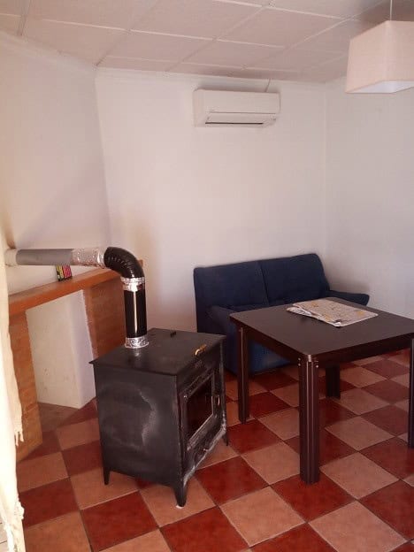 Commercial property in Gor, Granada with heating stove and seating area.