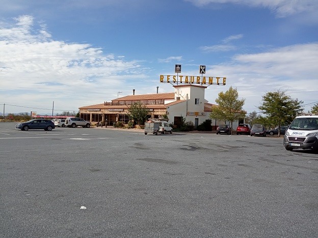 Restaurant in Gor, Granada with parking lot and blue sky.
