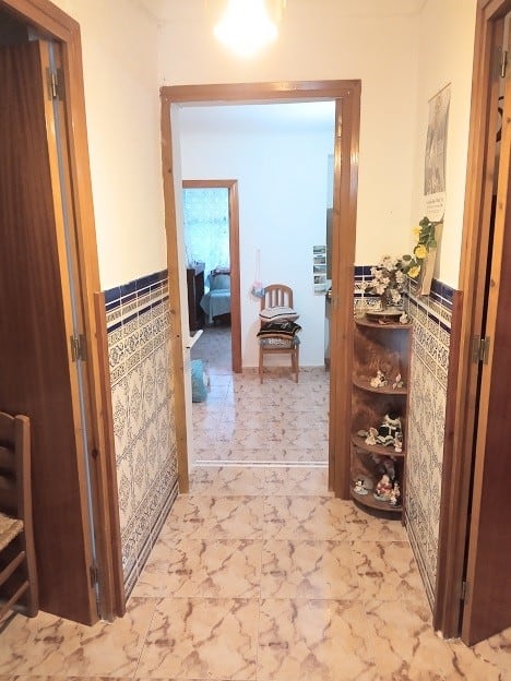 Charming village home entrance in Hinojares, Jaen, showcasing traditional architecture and cozy inte.