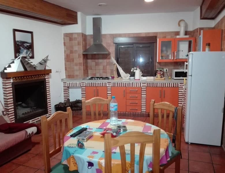Commercial kitchen in Seron, Almeria with modern appliances and cozy dining area.