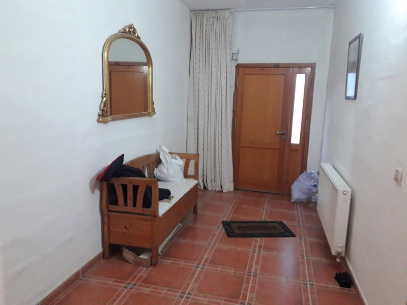 Charming town house interior in Seron, Almeria, featuring a cozy wooden bench and classic decor.
