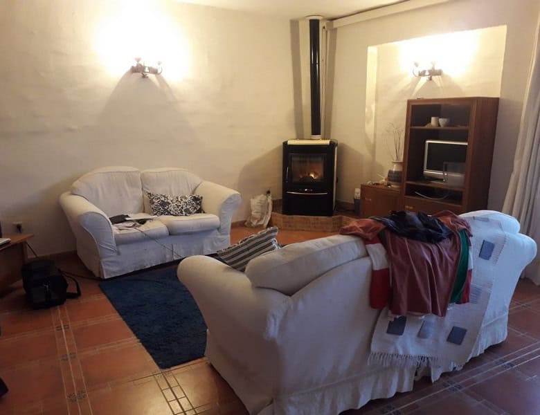 Comfortable living room with sofas, fireplace, and entertainment unit in a town house in Seron, Alme.