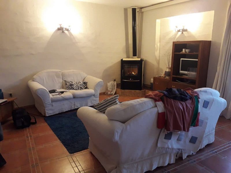 Comfortable living room with sofas, fireplace, and entertainment unit in a town house in Seron, Alme.