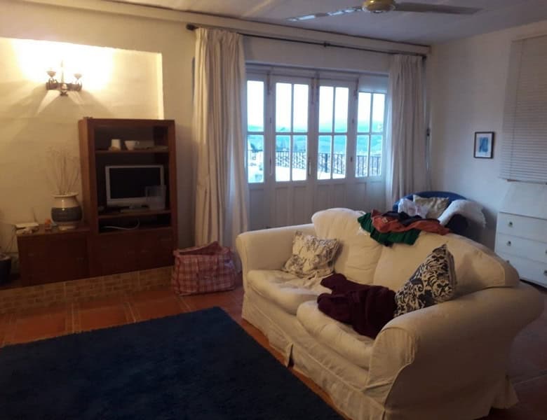Bright living room with sofa and large window in Seron, Almeria.
