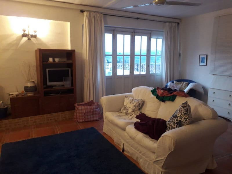 Bright living room with sofa and large window in Seron, Almeria.