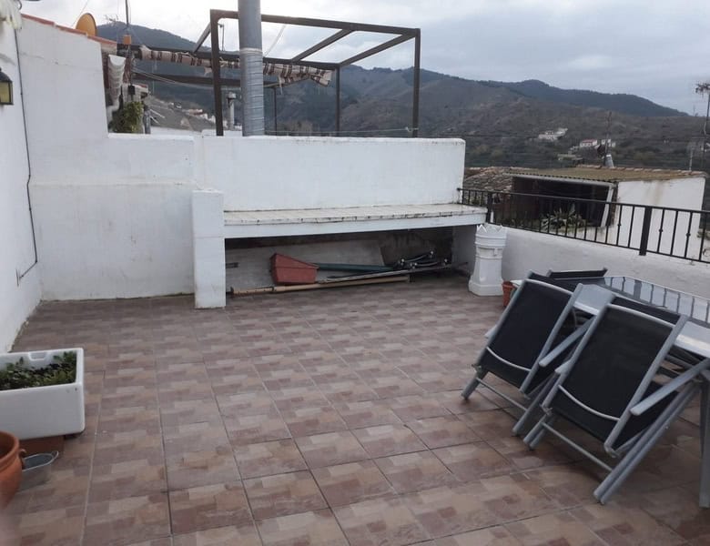 Terrace of a town house in Seron, Almeria with mountain views and outdoor seating.