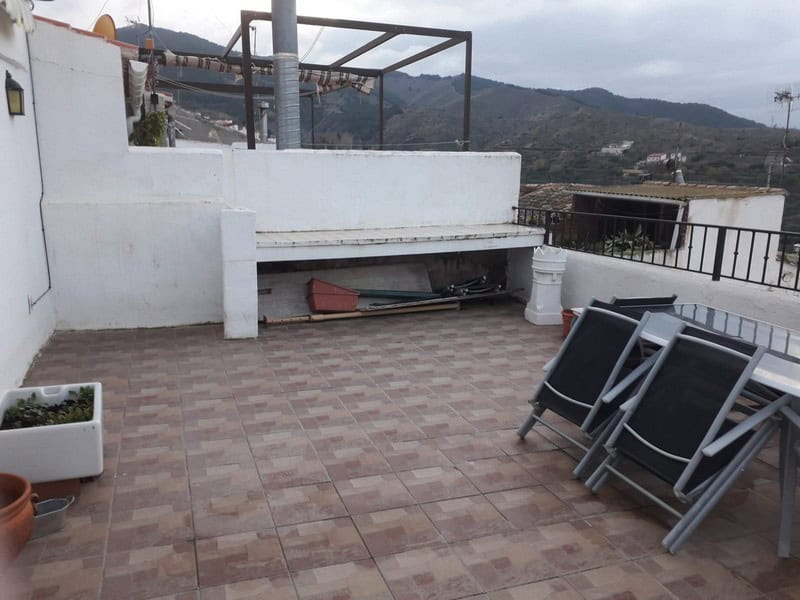 Terrace of a town house in Seron, Almeria with mountain views and outdoor seating.