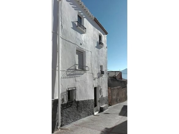 Charming village house in Somontin, Almeria, with white exterior walls and small balconies.