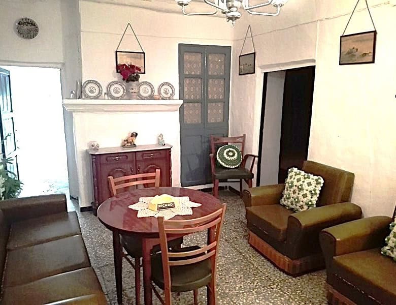 Charming interior of a village property in Somontin, Almeria, featuring traditional furniture and wa.
