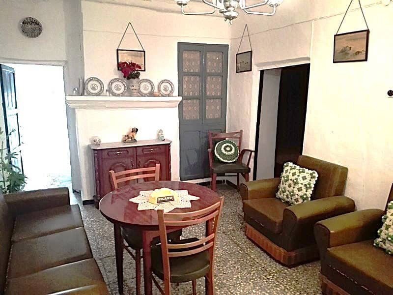 Charming interior of a village property in Somontin, Almeria, featuring traditional furniture and wa.