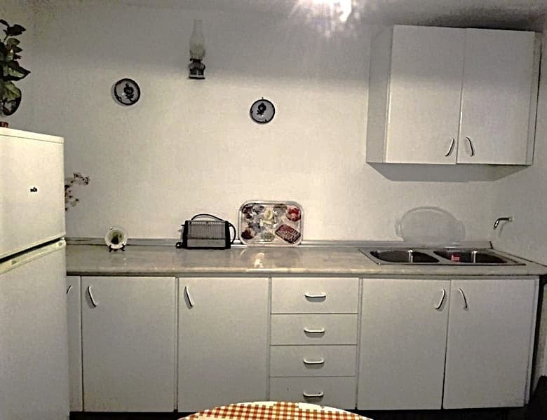 Charming village property kitchen in Somontin, Almeria with white cabinets and basic appliances.