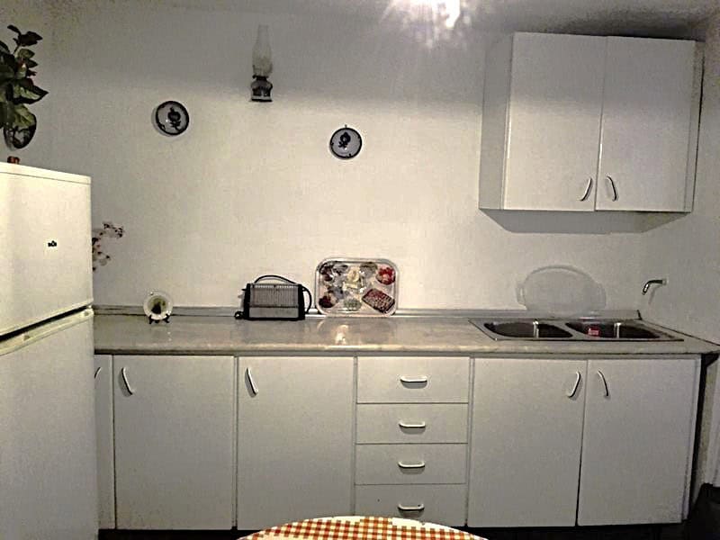 Charming village property kitchen in Somontin, Almeria with white cabinets and basic appliances.