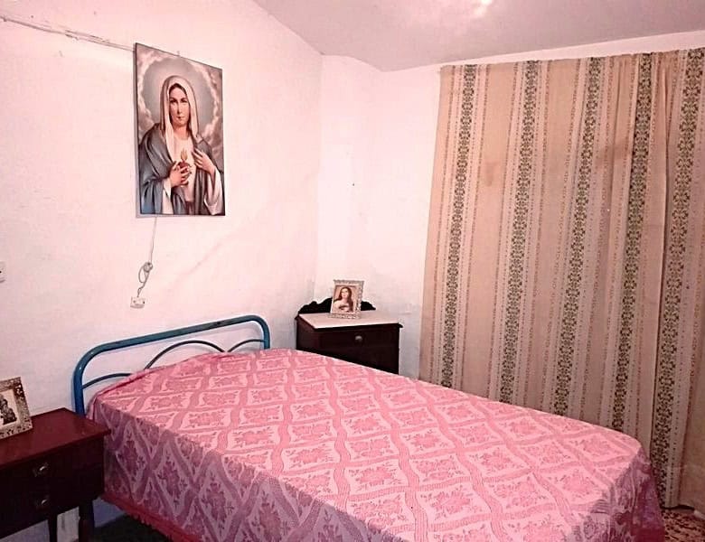 Cozy bedroom in a traditional village property in Somontin, Almeria, featuring simple decor and a re.