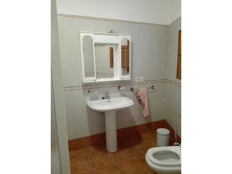 Charming bathroom in a village property in Seron, Almeria, featuring a white sink, mirror, and basic.
