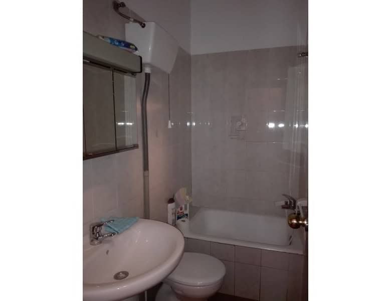 Cozy bathroom with bathtub, sink, and toilet in a traditional village property in Seron, Almeria.