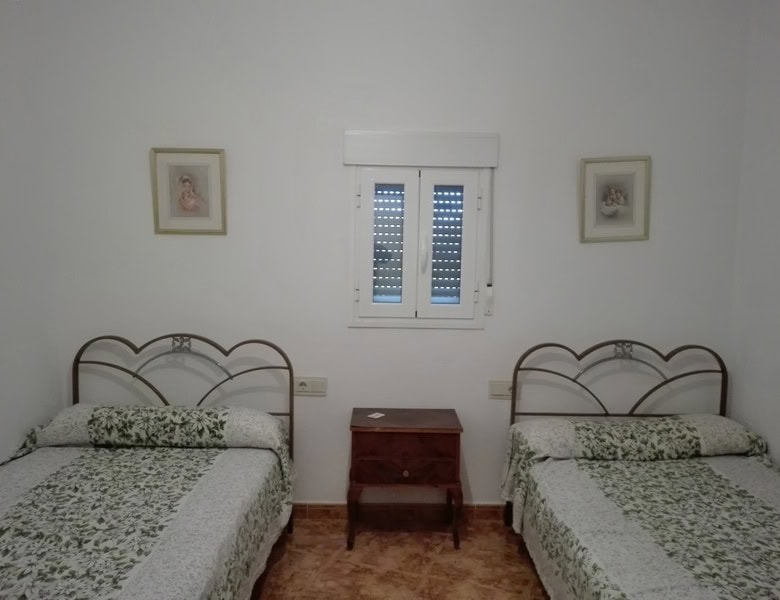 Cozy twin bedroom in village property in Seron, Almeria, with simple decor and natural light.