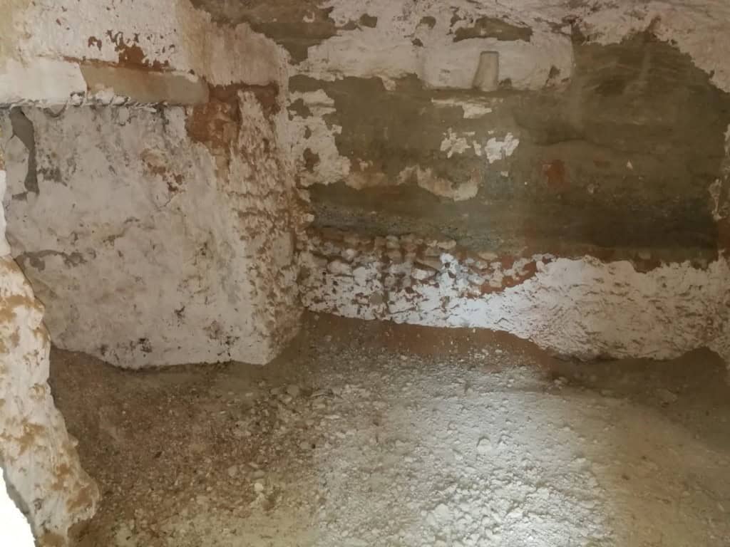 Cave house interior with rustic stone walls in Baza, Granada, ideal for renovation or conversion pro.