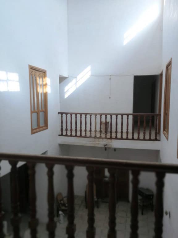 Interior view of a traditional village house in Campo Camara, Granada, showcasing wooden railings an.