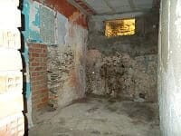 Interior view of a rustic village property in Seron, Almeria, showing exposed brick walls and unfini.