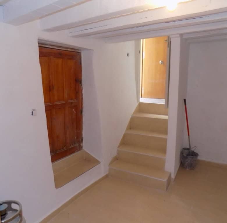 Village property interior with staircase and wooden window in Sierro, Almeria.