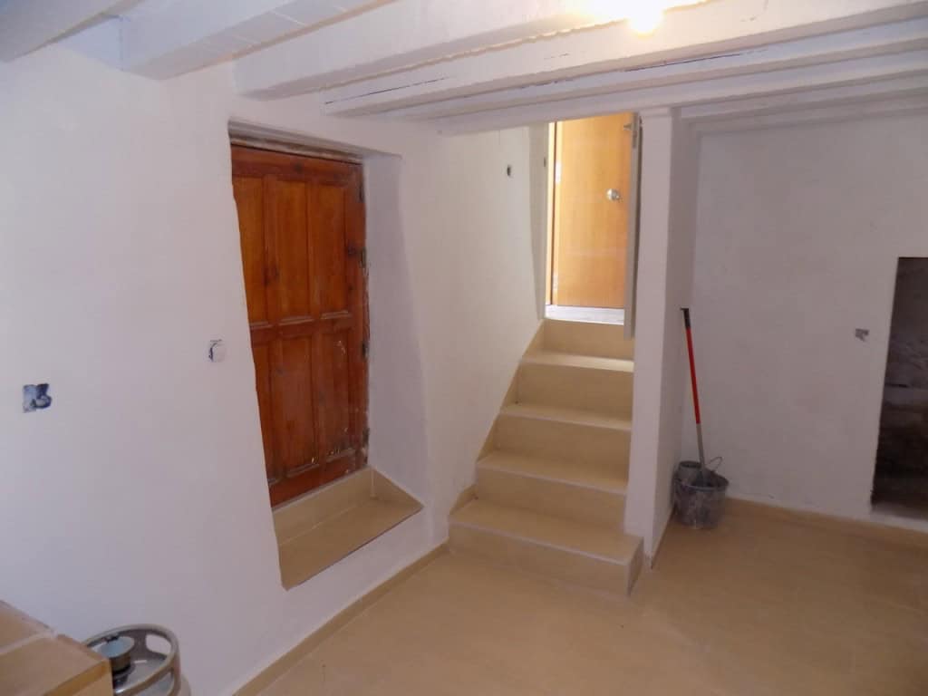 Village property interior with staircase and wooden window in Sierro, Almeria.