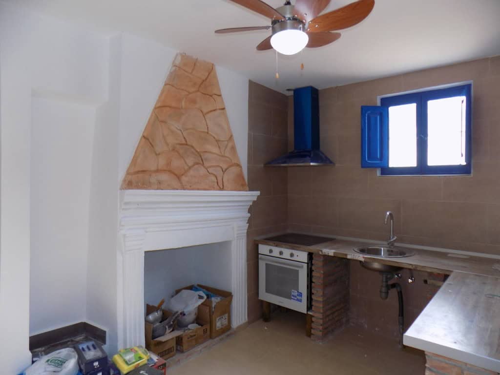 Cozy kitchen in village property, Sierro, Almeria with rustic features and modern appliances.