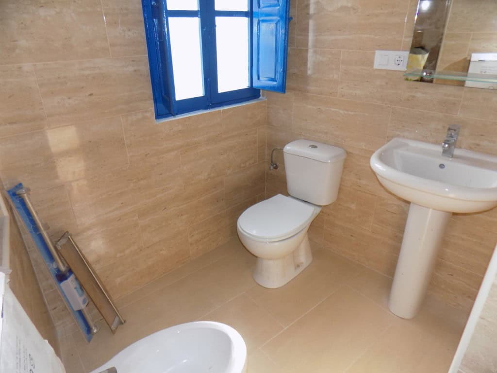 Cozy bathroom with modern fixtures in a traditional village home in Sierro, Almeria.
