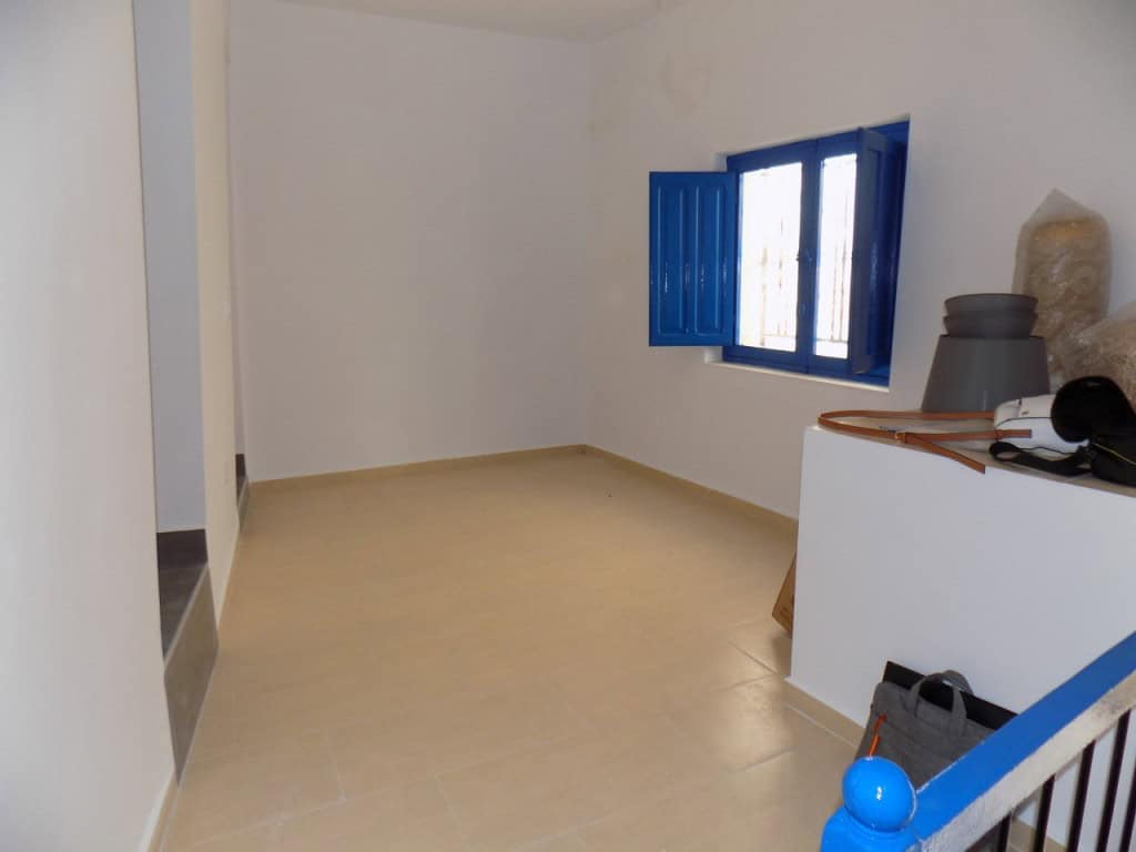Charming village property in Sierro, Almeria with bright interior and traditional blue window shutte.