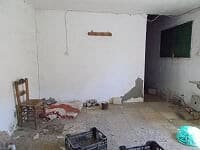Interior view of a rural property in Sufli, Almeria, showing an unfinished room with basic furnishin.