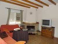 Charming rural home interior in Oria, Almeria with cozy living room, fireplace, and traditional deco.