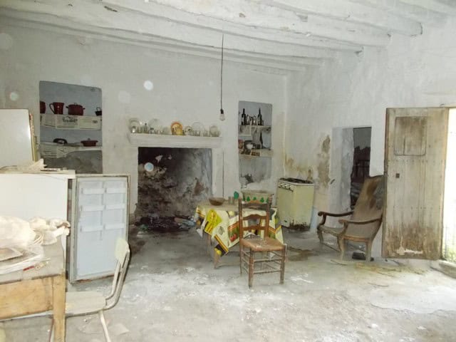 Village property interior with rustic furniture and traditional fireplace in Tijola, Almeria.