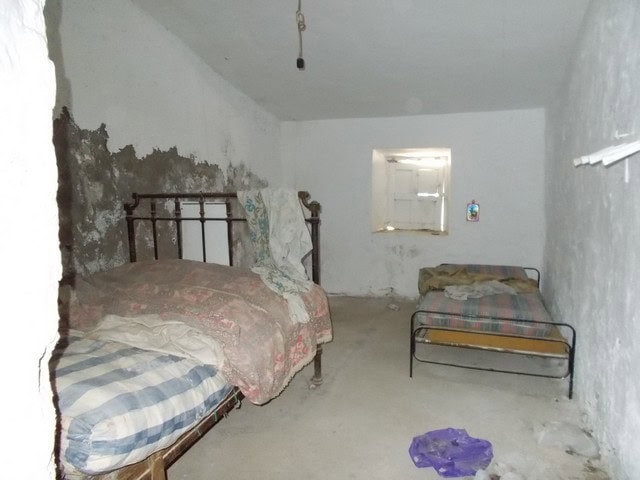 Charming interior of a village property in Tijola, Almeria, featuring rustic walls and simple furnis.