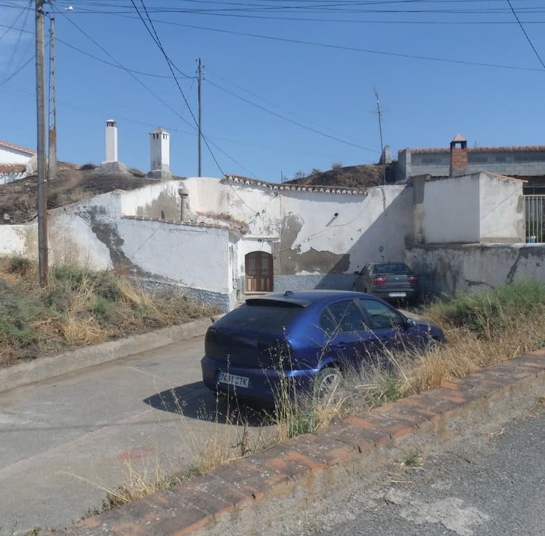 Cave house in Guadix, Granada with whitewashed walls and traditional architecture.