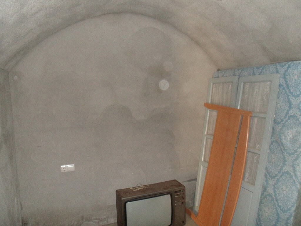 Cave house interior in Guadix, Granada, showcasing traditional underground living space.