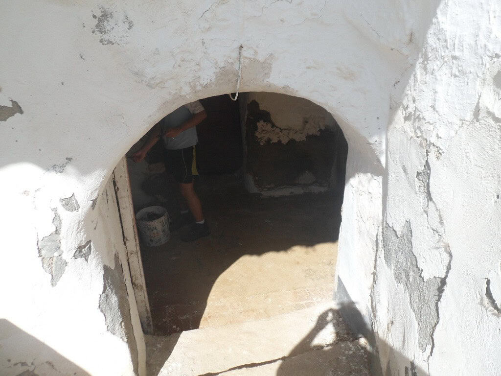 Cave house entrance in Guadix, Granada, showcasing traditional subterranean architecture.