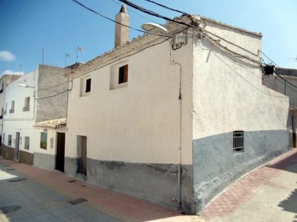 Traditional town house in Tijola, Almeria, featuring whitewashed walls and a chimney.