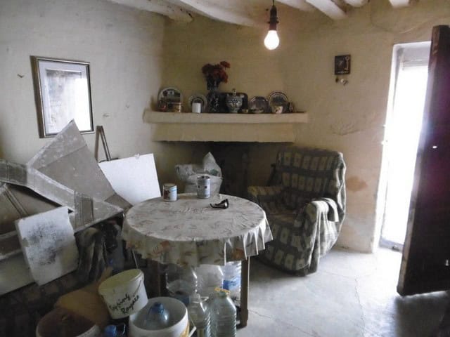 Cozy living room in a traditional Tijola town house, Almeria, featuring rustic decor and vintage fur.
