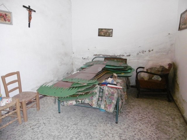 Interior of a rustic town house in Tijola, Almeria, showing a simple room with old furniture and wor.