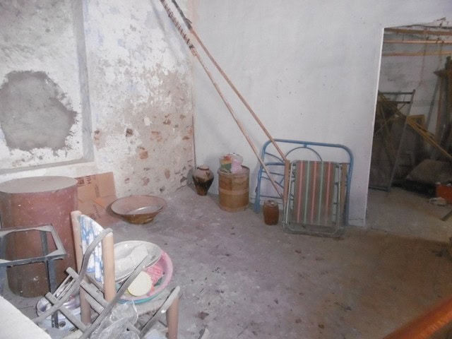 Town house interior in Tijola, Almeria, showing rustic walls and simple furnishings.