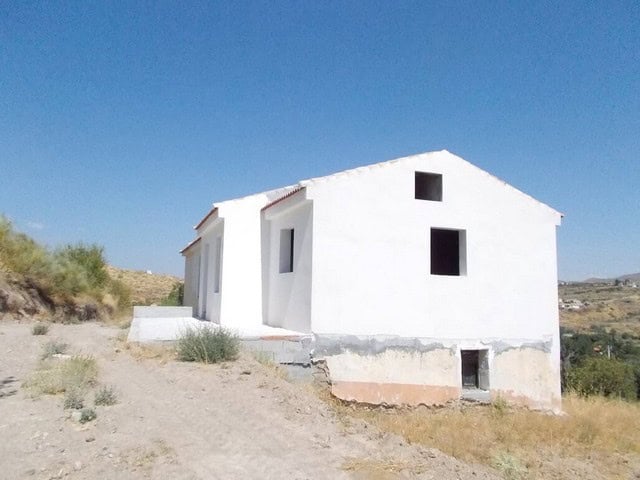 Rural property for sale in Seron, Almeria, featuring a whitewashed house in a scenic countryside set.