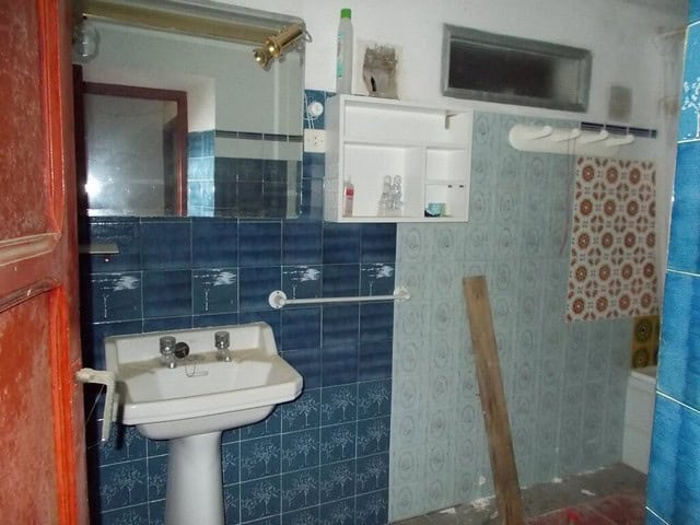 Traditional rural bathroom in Seron, Almeria with vintage sink and tiled walls.