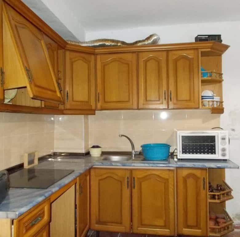 Kitchen with wooden cabinets and modern appliances in Seron village, Almeria.