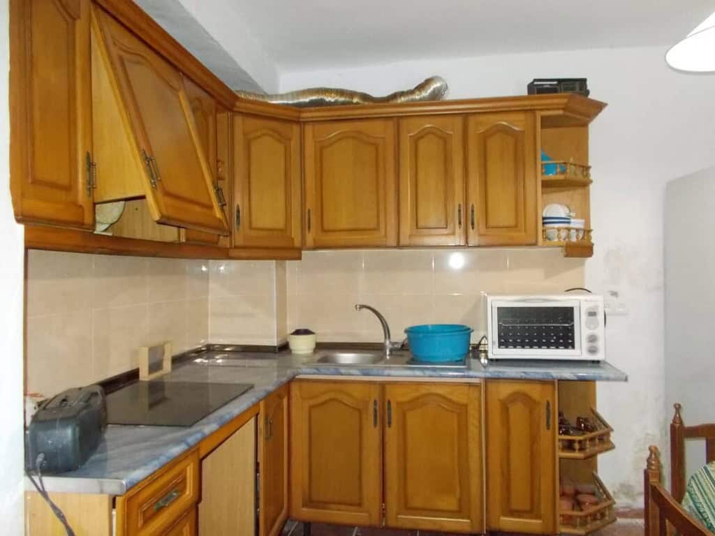 Kitchen with wooden cabinets and modern appliances in Seron village, Almeria.