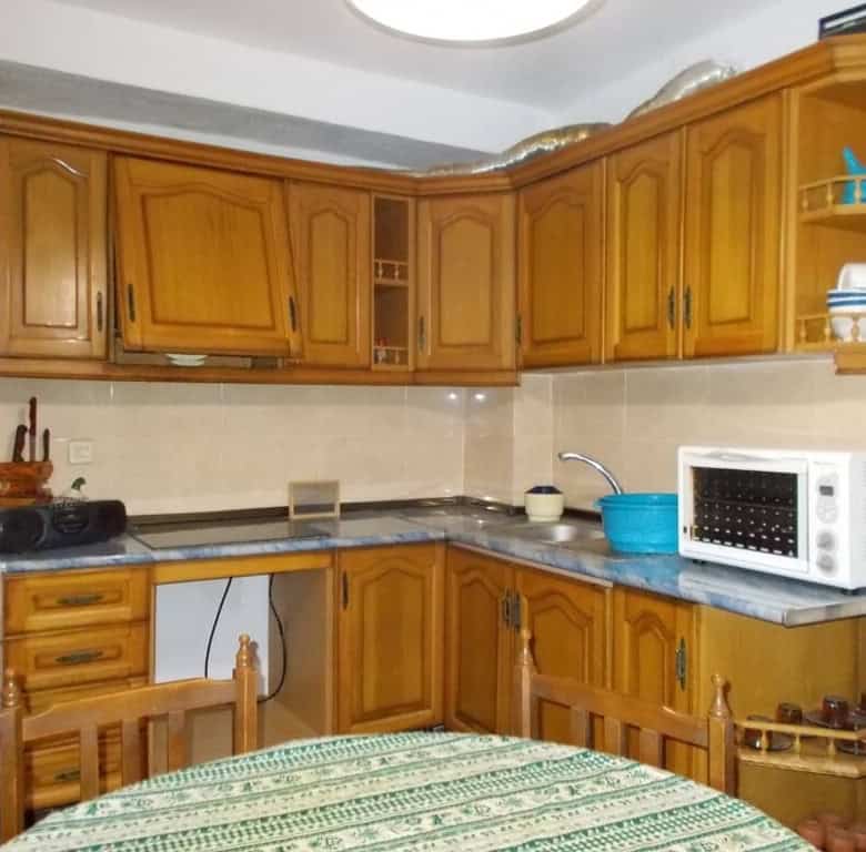 Charming kitchen in a traditional village property in Seron, Almeria, featuring wooden cabinets and.