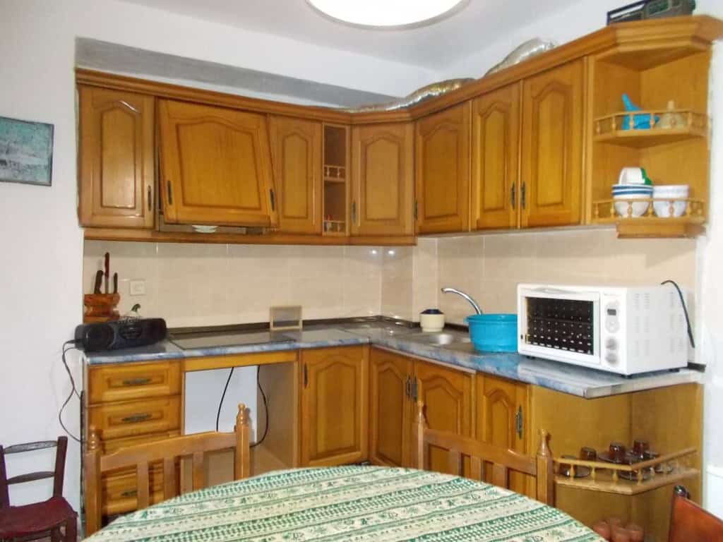 Charming kitchen in a traditional village property in Seron, Almeria, featuring wooden cabinets and.