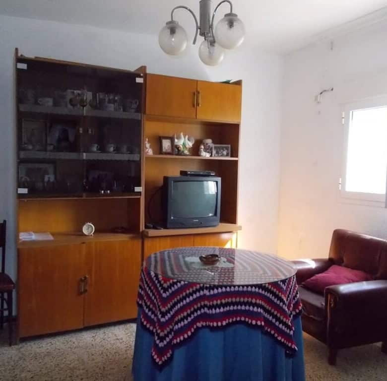 Charming village property in Seron, Almeria, featuring a simple living room with vintage furniture a.